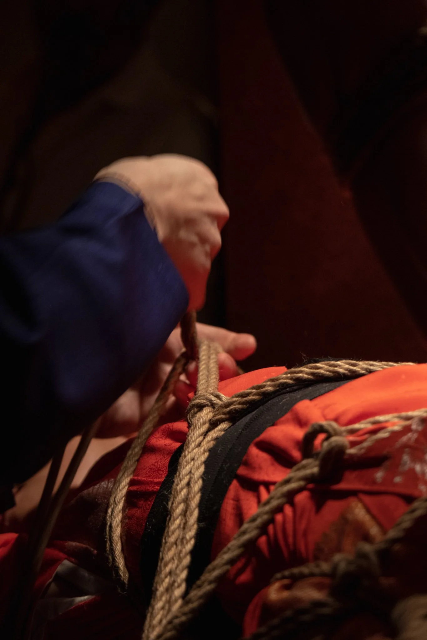 Hands preparing shibari ropes